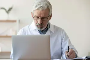 Doctor reviewing patient information on a computer