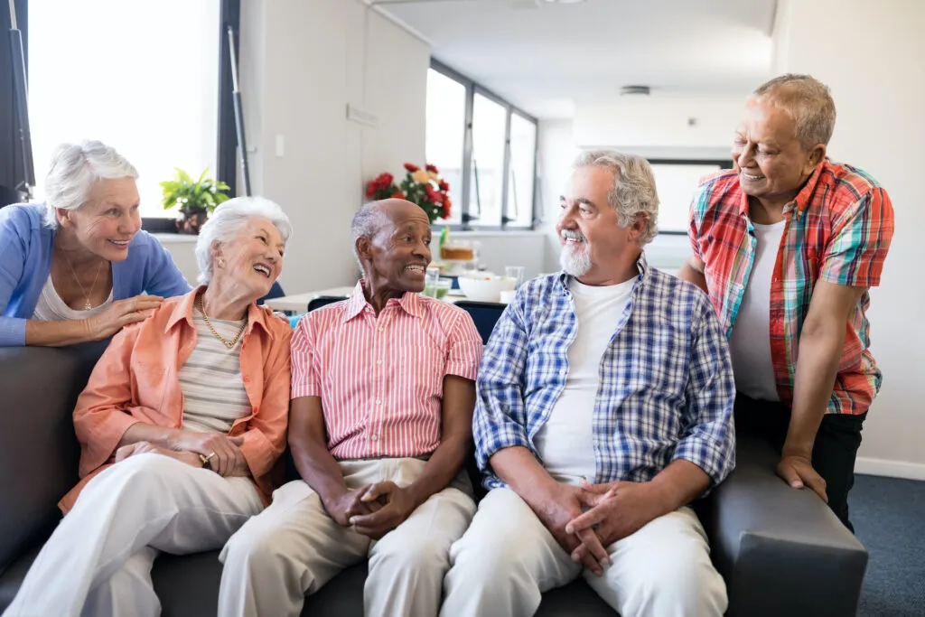 Group of happy senior adults sitting together and socializing