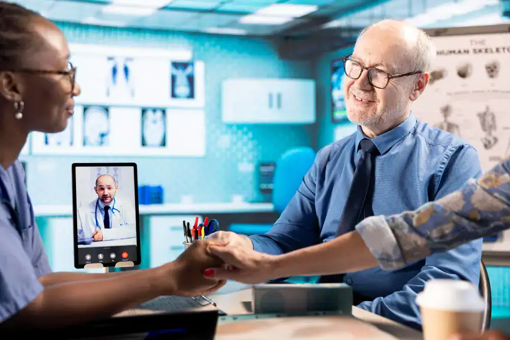 Doctor consulting with patients in clinic while conducting virtual telemedicine appointment