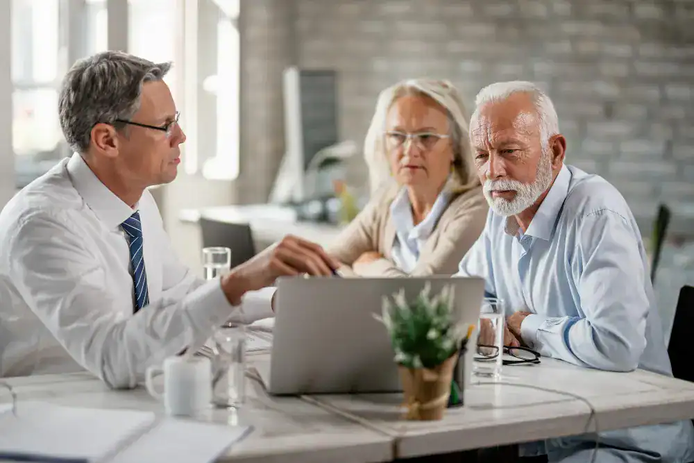Doctor discussing coordinated care with an older adult couple