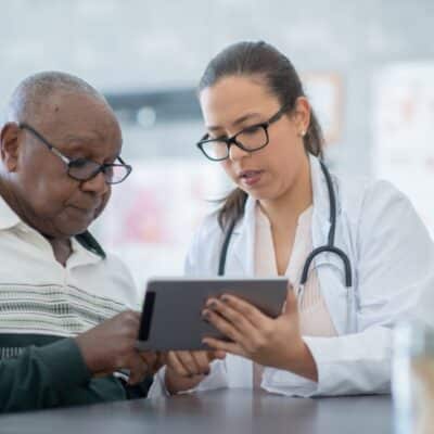 Doctor consulting with an older patient